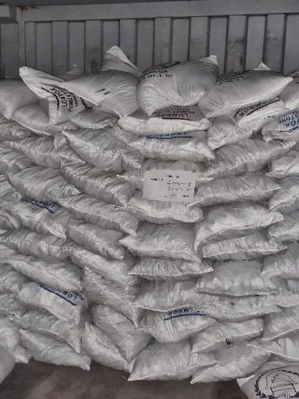 First wall of pumice bags stacked at the back of the container